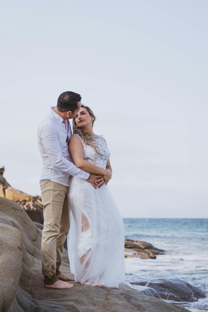 A Romantic Couple Embracing on the Beach