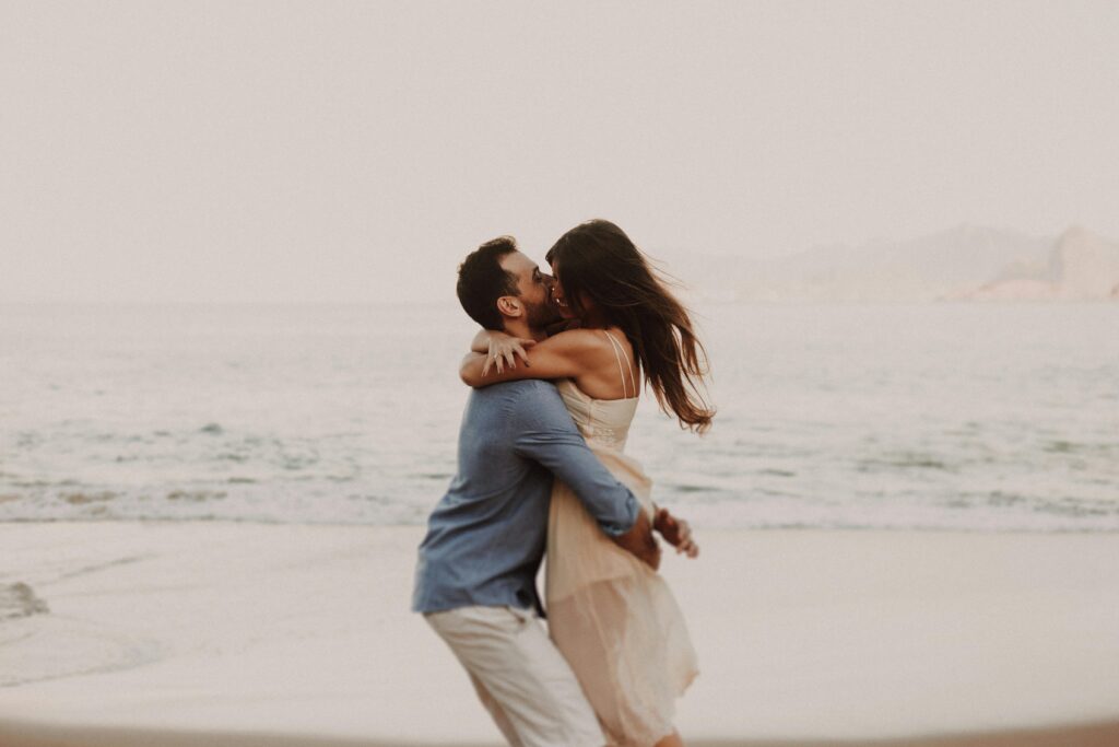 pexels-photo-14106978-14106978 A couple shares a romantic embrace by the ocean, capturing a moment of love.