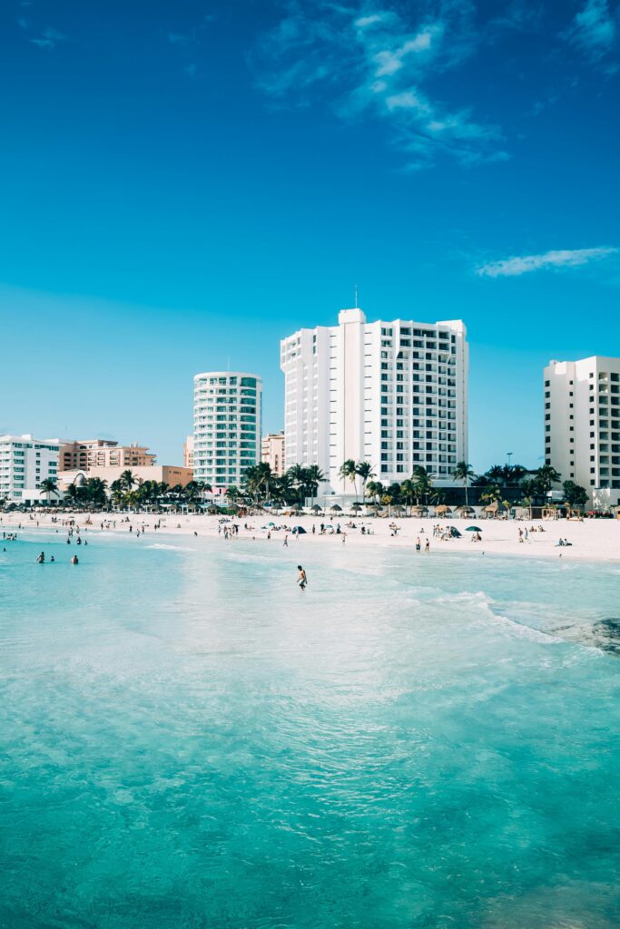 pexels-photo-1802255-1802255 Scenic view of modern hotels along the beachfront in Cancun, Mexico, with clear blue waters.